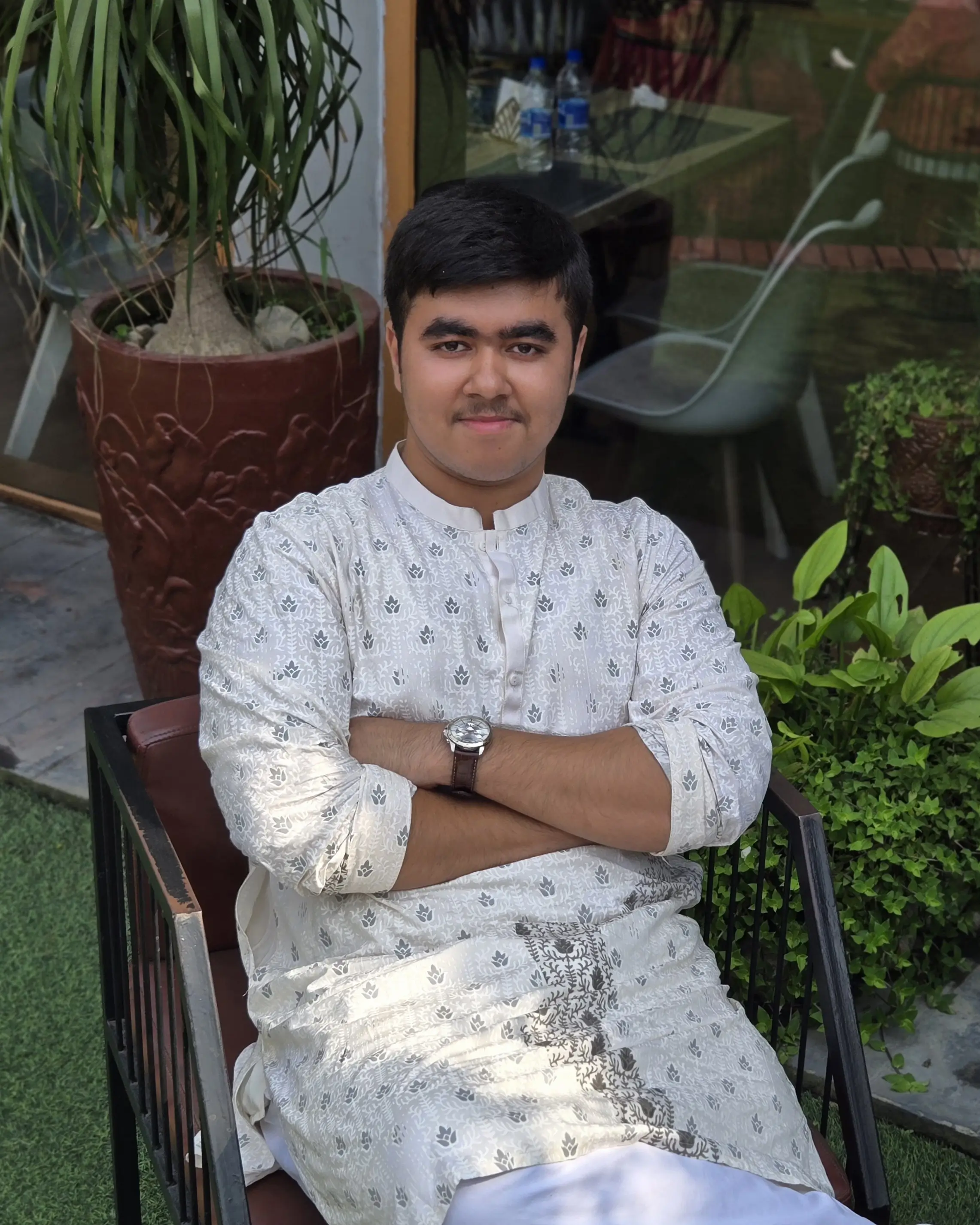 Wesley Deep Biswas smiling in a sunlit studio portrait